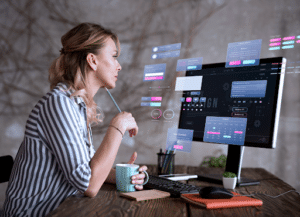 Web design expert reviewing UI on desktop in a modern workspace.